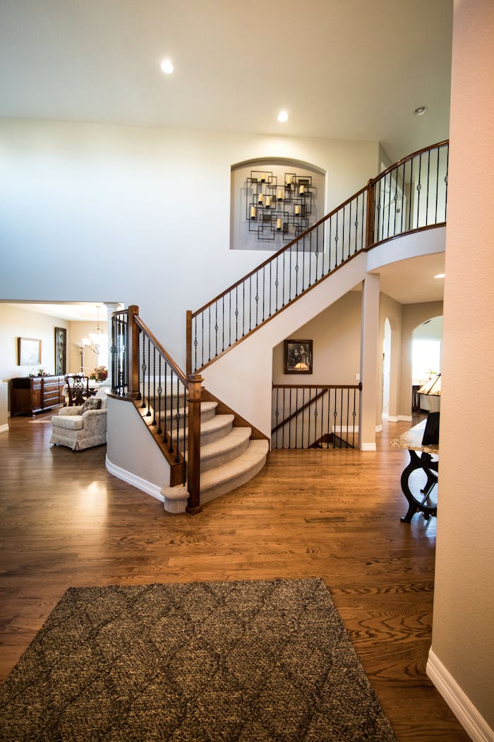 gallery-1 Spacious modern interior showcasing a stylish wooden staircase and elegant decor.